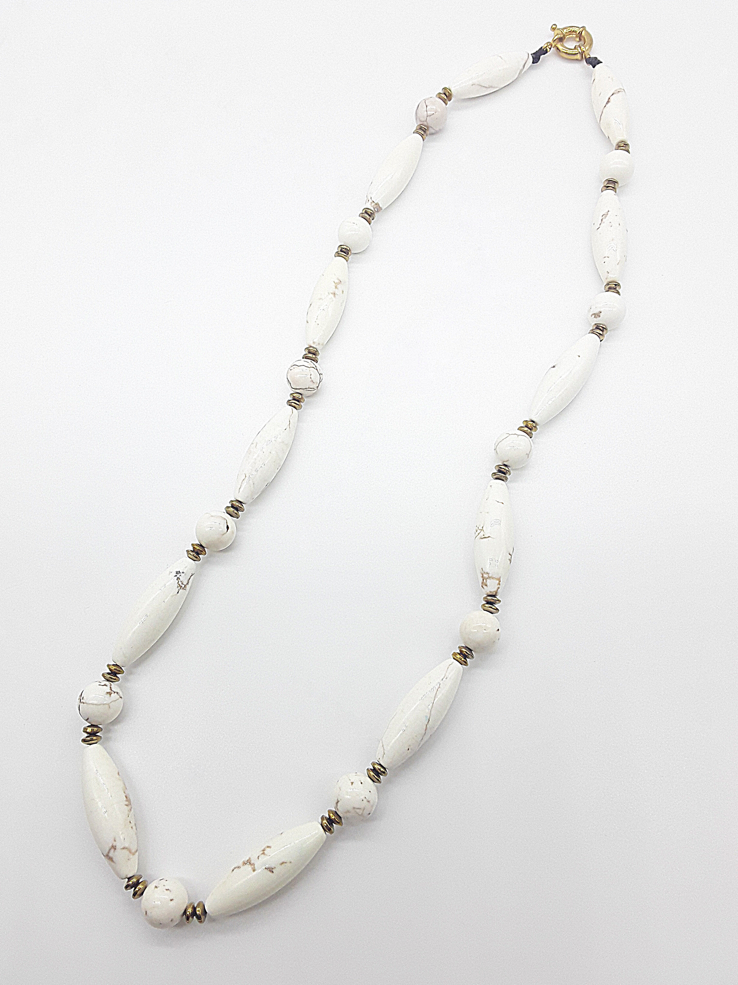 The Ivory Dawn Necklace by Polmadeva – Turquoise and Hematite necklace symbolizing purity, balance, and renewal with gold clasp.