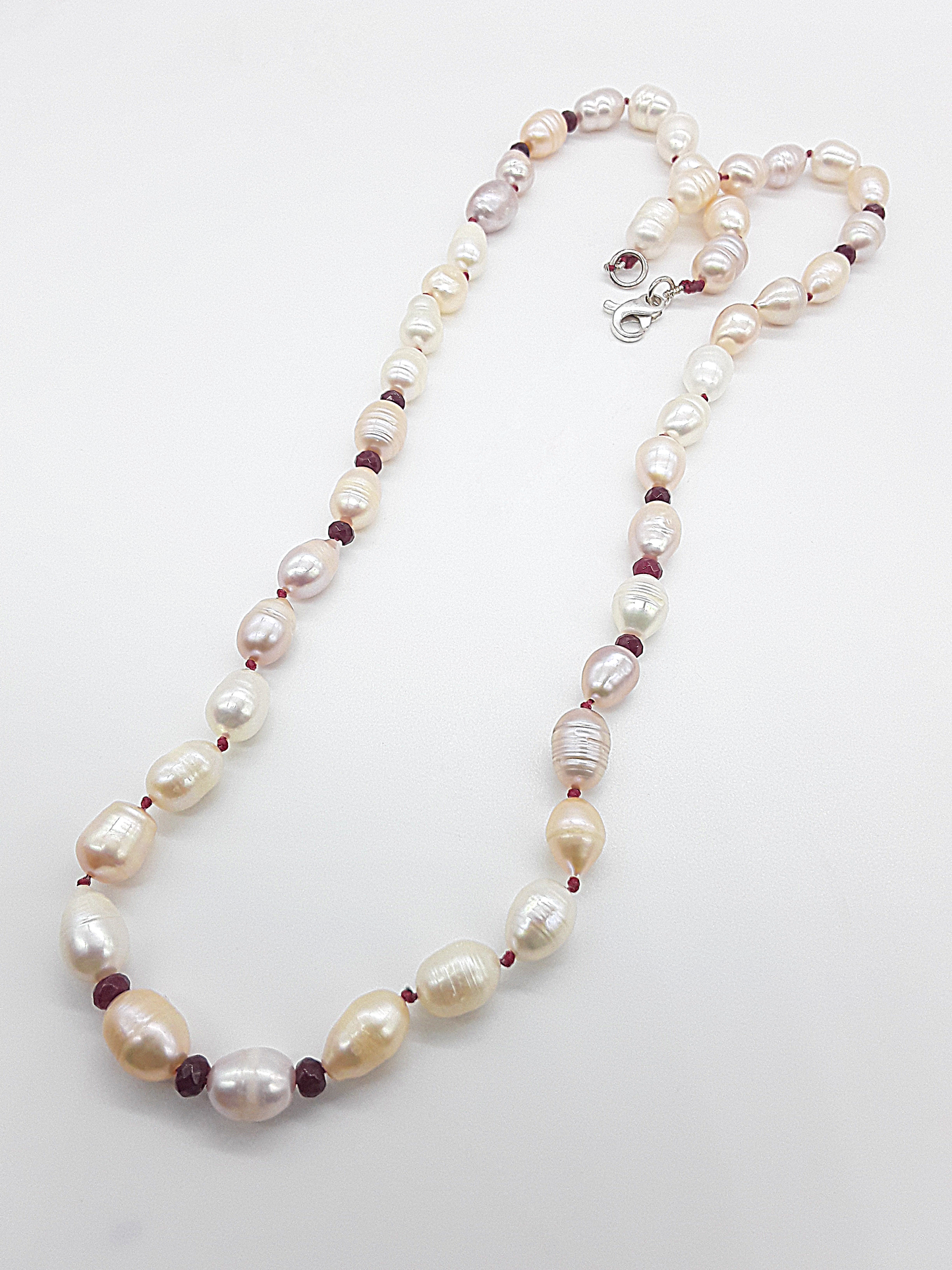 The Pearl of Fire Necklace by Polmadeva – freshwater pearls and ruby beads necklace symbolizing elegance, passion, and rebirth