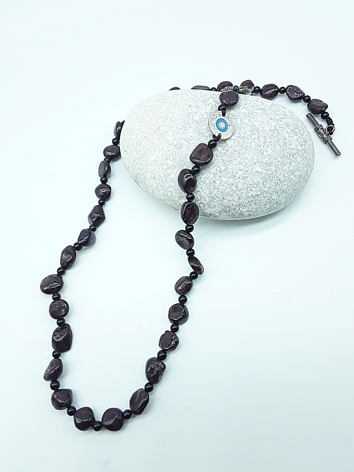The Sigilguard Necklace by Polmadeva – garnet and onyx necklace with sigil pendant symbolizing protection, courage, and resilience