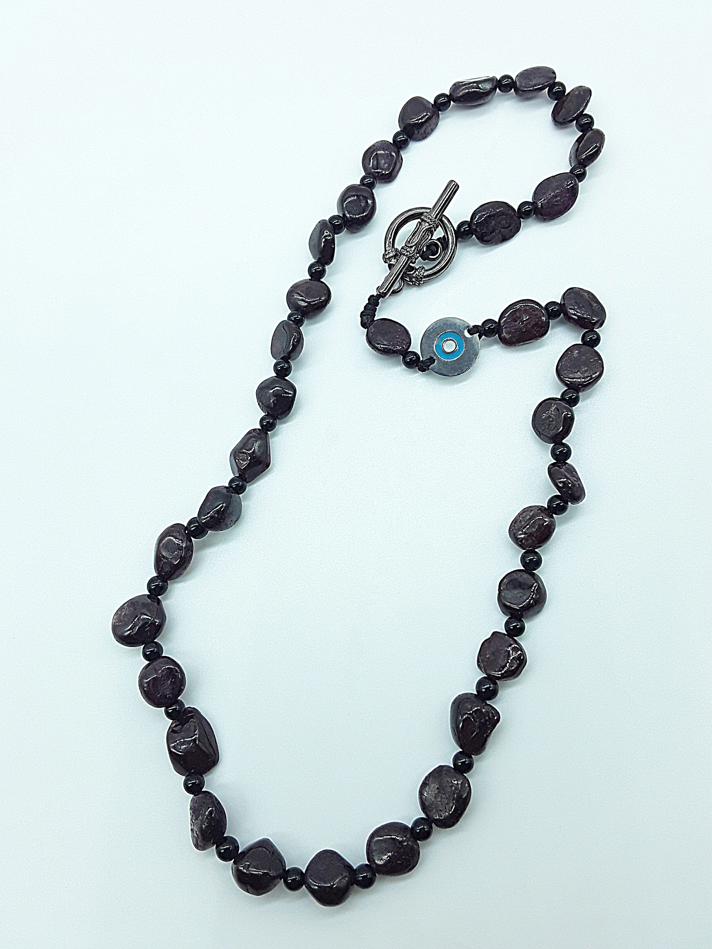 The Sigilguard Necklace by Polmadeva – garnet and onyx necklace with sigil pendant symbolizing protection, courage, and resilience
