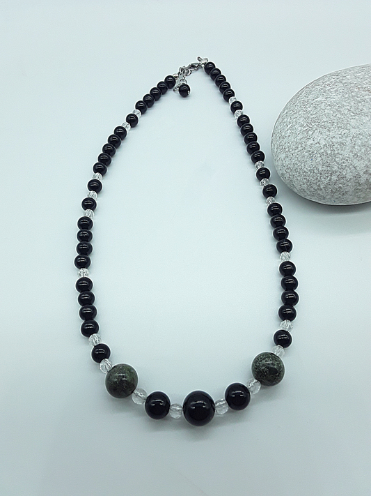 Handcrafted Stillwatch Guardian Necklace with black onyx beads, natural quartz crystal and dragon blood stone on neutral background