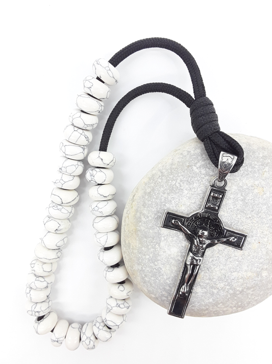 Howlite Paracord Orthodox Rosary resting on natural stone surface with stainless steel crucifix by Polmadeva.