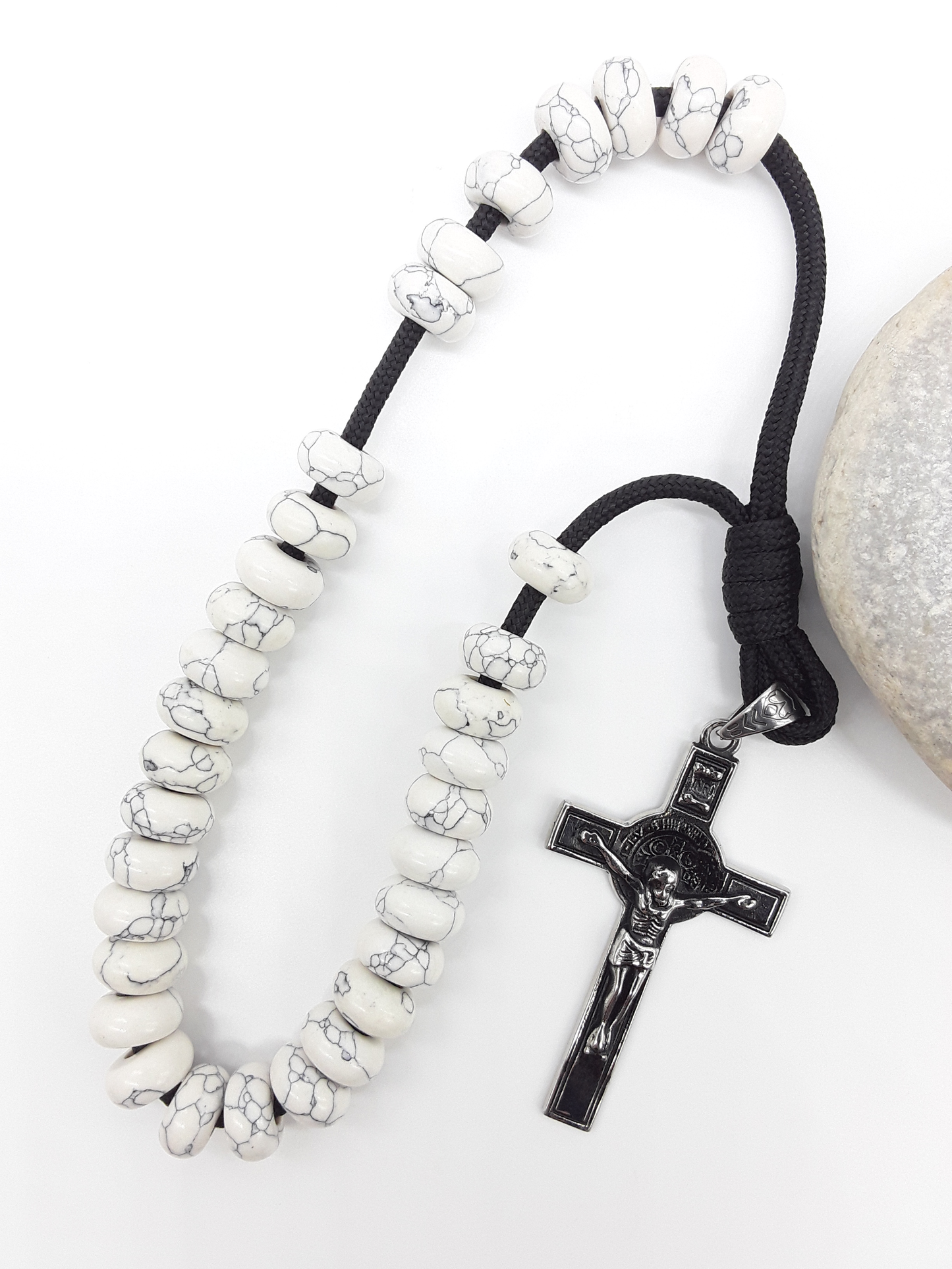 Howlite Paracord Orthodox Rosary with stainless steel crucifix beside natural stone surface by Polmadeva.