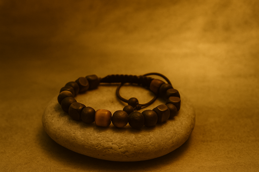 Handcrafted Polmadeva bracelet on stone under golden light.