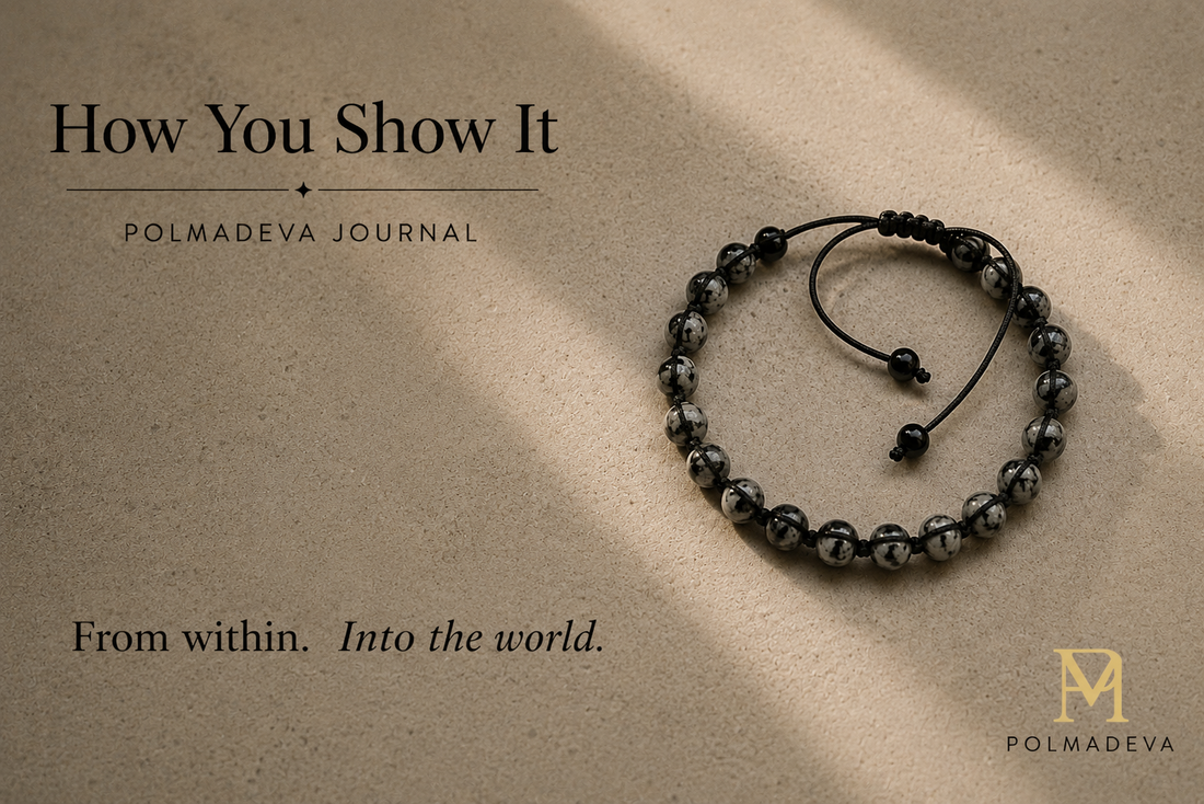 Beaded bracelet on a warm textured surface with soft directional light, titled “How You Show It”, Polmadeva logo bottom right.