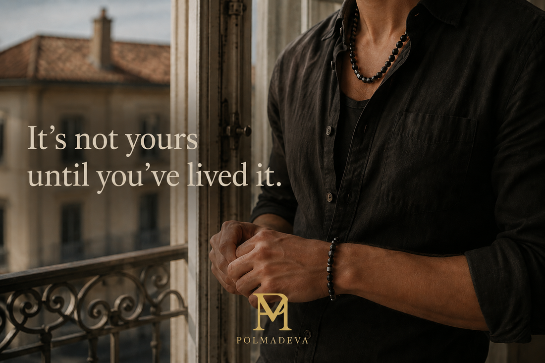 Handcrafted black gemstone necklace and bracelet by Polmadeva worn naturally in soft daylight during a calm moment by a window.