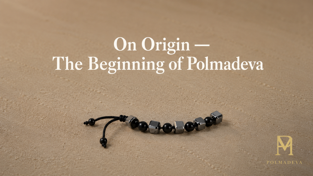 Minimal stone surface with a partially curved bracelet segment, titled “On Origin — The Beginning of Polmadeva”, Polmadeva logo bottom right.