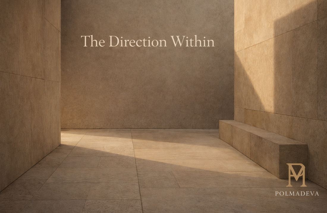 Minimal architectural courtyard in warm stone tones with soft afternoon light and diagonal shadows, titled “The Direction Within,” Polmadeva logo bottom right.