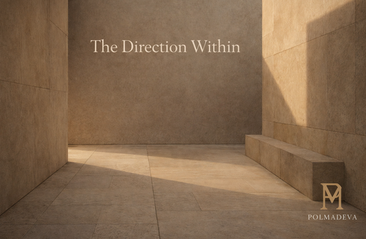 Minimal architectural courtyard in warm stone tones with soft afternoon light and diagonal shadows, titled “The Direction Within,” Polmadeva logo bottom right.