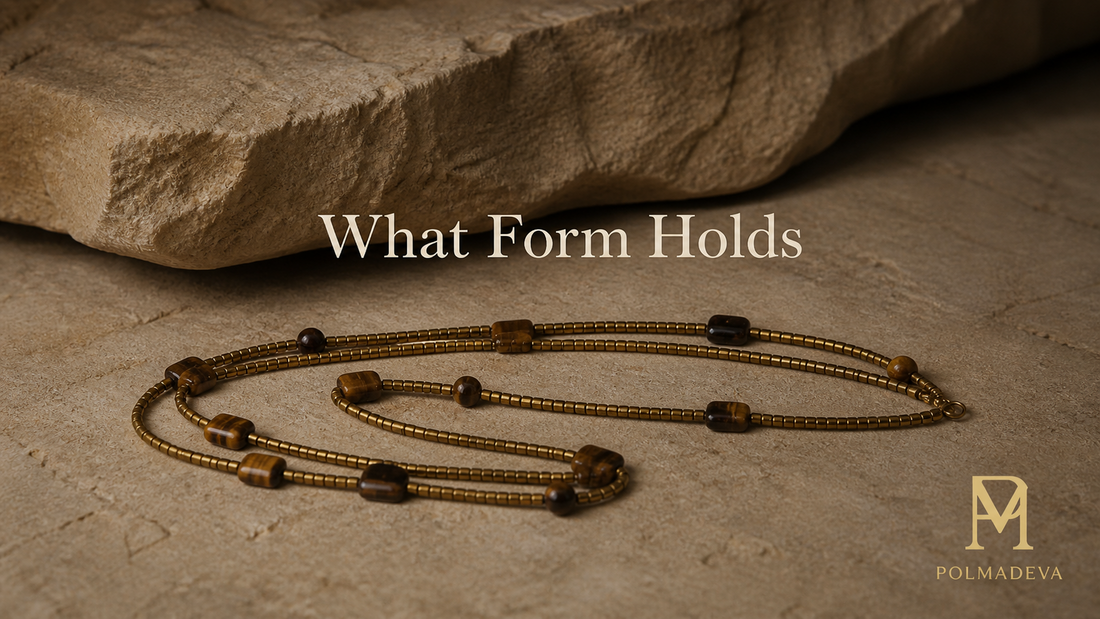 Minimal stone surface with softly lit bracelet resting in a gathered form, titled “What Form Holds”, Polmadeva logo bottom right.