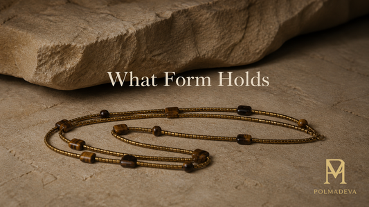 Minimal stone surface with softly lit bracelet resting in a gathered form, titled “What Form Holds”, Polmadeva logo bottom right.