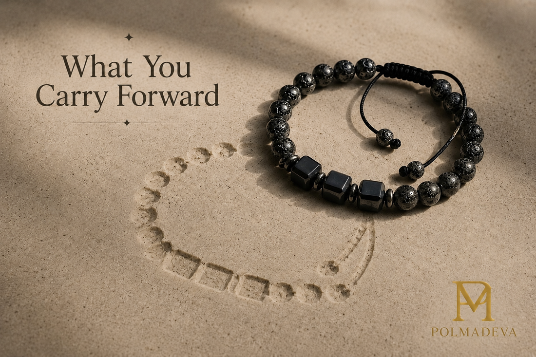 Bracelet resting on a sandy surface with a subtle imprint beneath it, titled “What You Carry Forward”, Polmadeva logo bottom right.