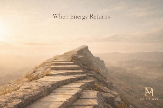 Stone pathway ascending along a mountain ridge in warm golden morning light, titled “When Energy Returns,” with the Polmadeva logo in the lower right corner.
