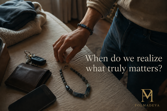 A quiet indoor moment where a person organizes personal items on a surface, with a bracelet placed among everyday objects, alongside the text “When do we realize what truly matters?” and the Polmadeva logo.