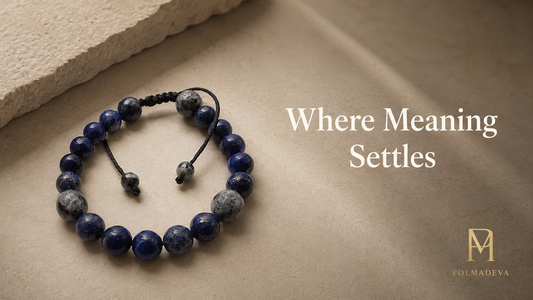 Bracelet arranged in a circular form on a warm stone surface, titled “Where Meaning Settles”, Polmadeva logo bottom right.