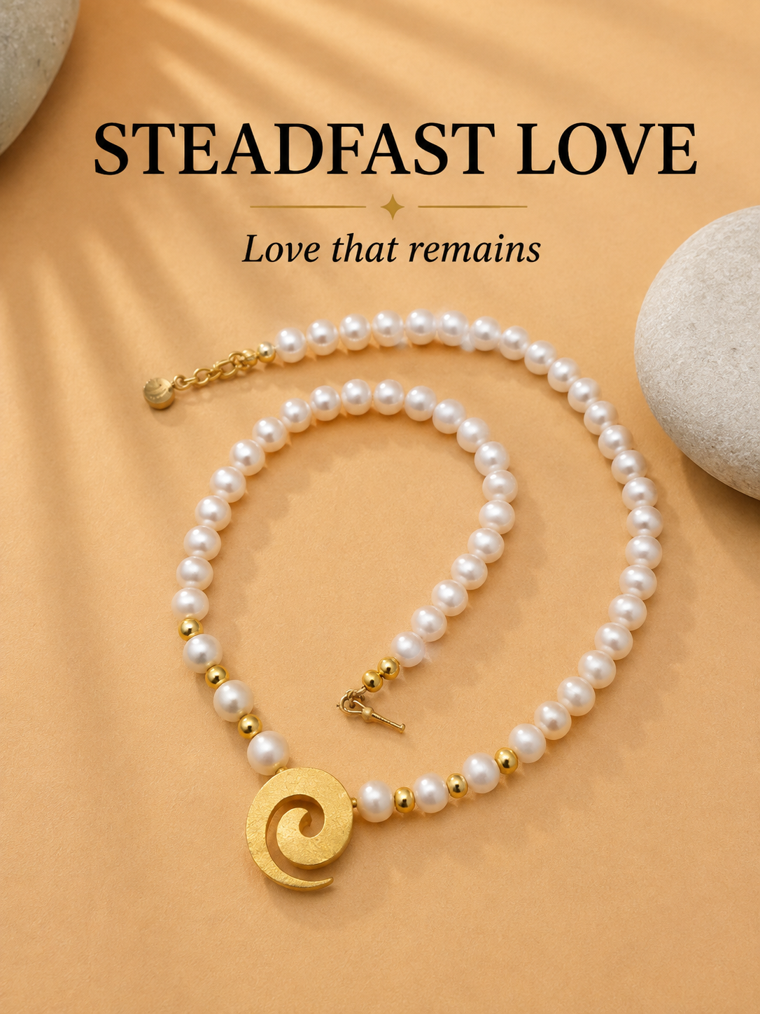A pearl necklace with gold spacer beads and a gold spiral pendant, arranged on a warm beige fabric background with decorative stones. Text at the top reads 'STEADFAST LOVE' and 'Love that remains' by POLMADEVA.