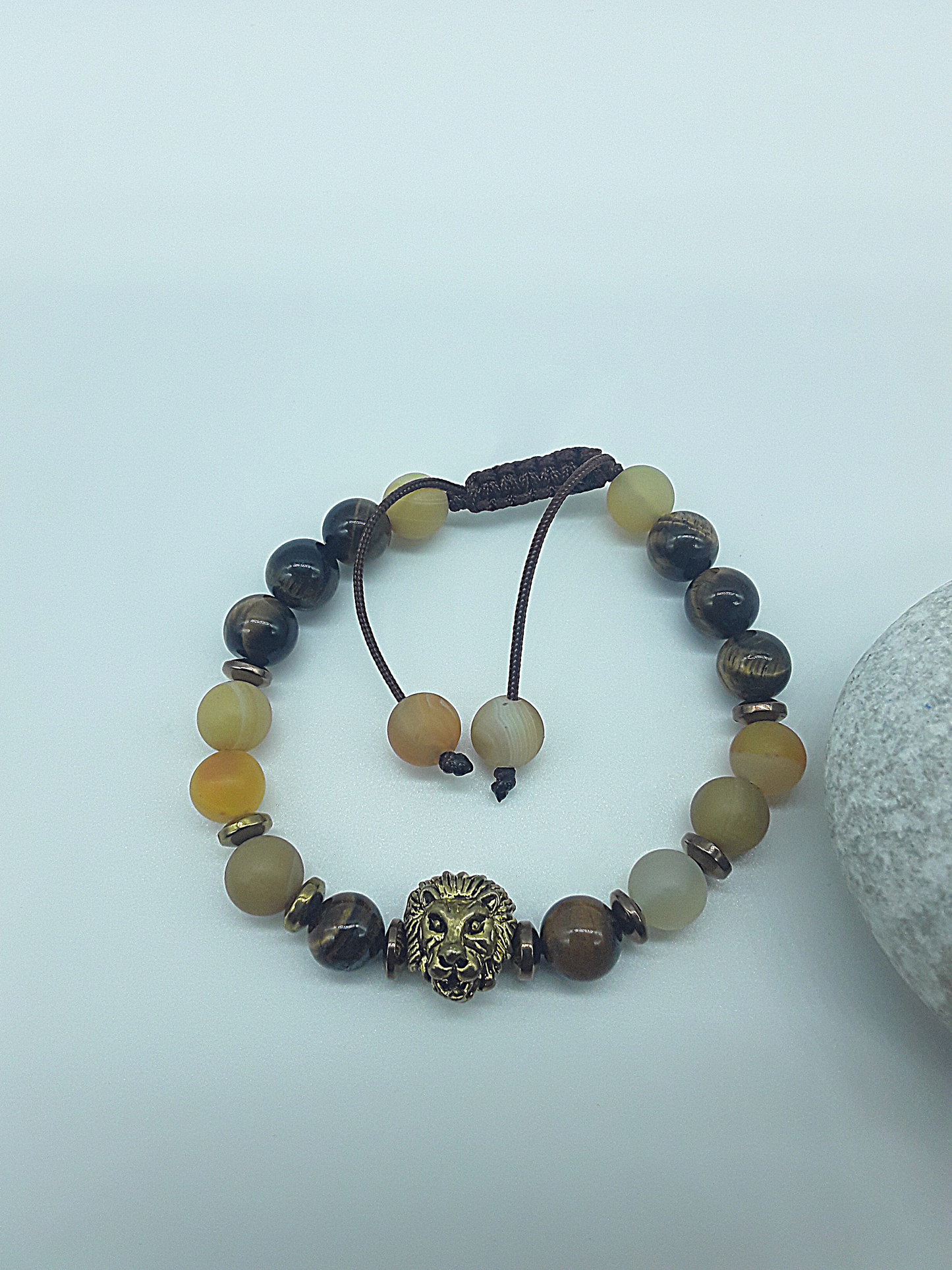 The Lion’s Balance Bracelet by Polmadeva – Tiger’s Eye, Agate & Hematite bracelet with metallic lion charm symbolizing harmony, courage & grounding.