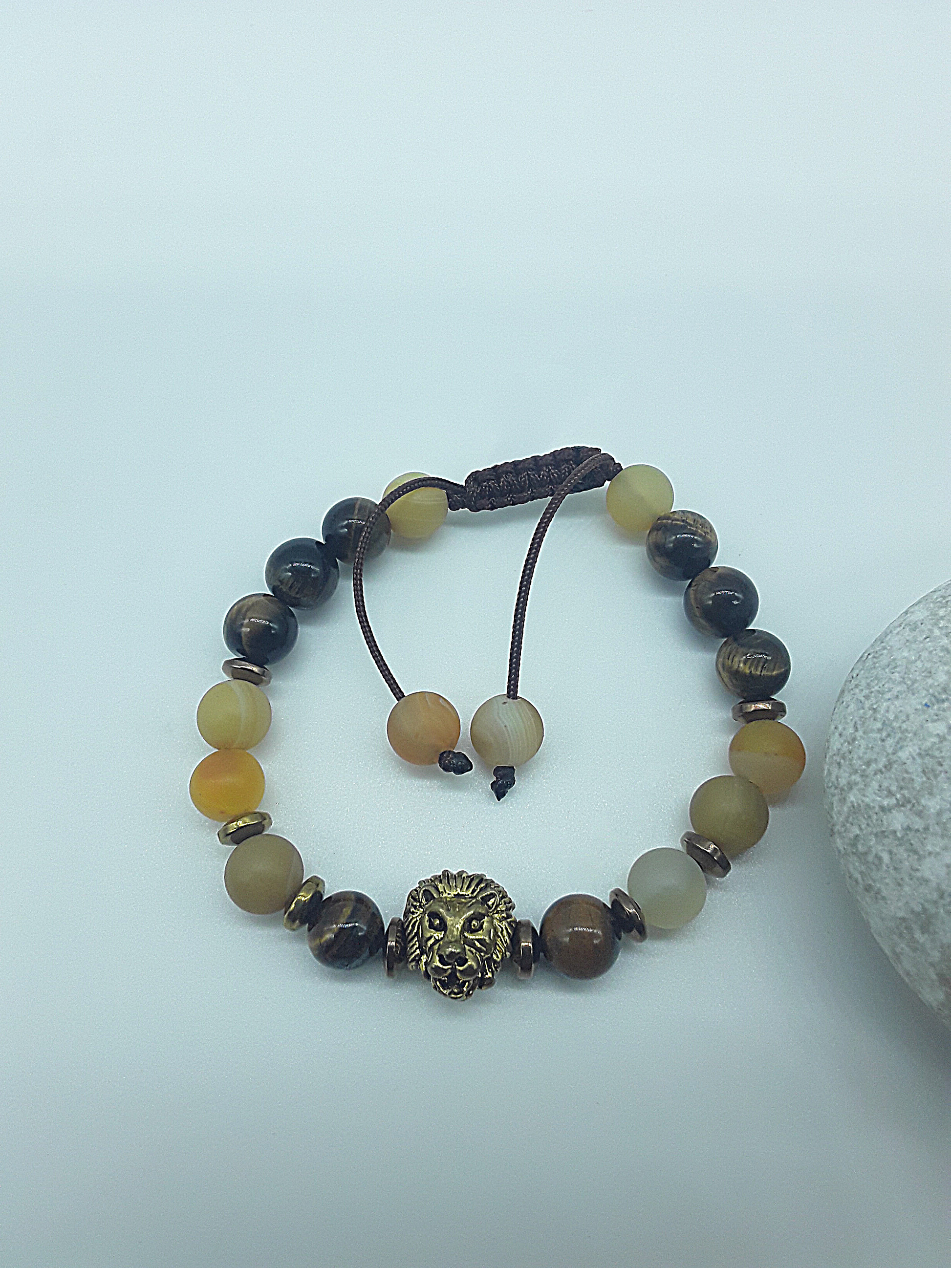 The Lion’s Balance Bracelet by Polmadeva – Tiger’s Eye, Agate & Hematite bracelet with metallic lion charm symbolizing harmony, courage & grounding.