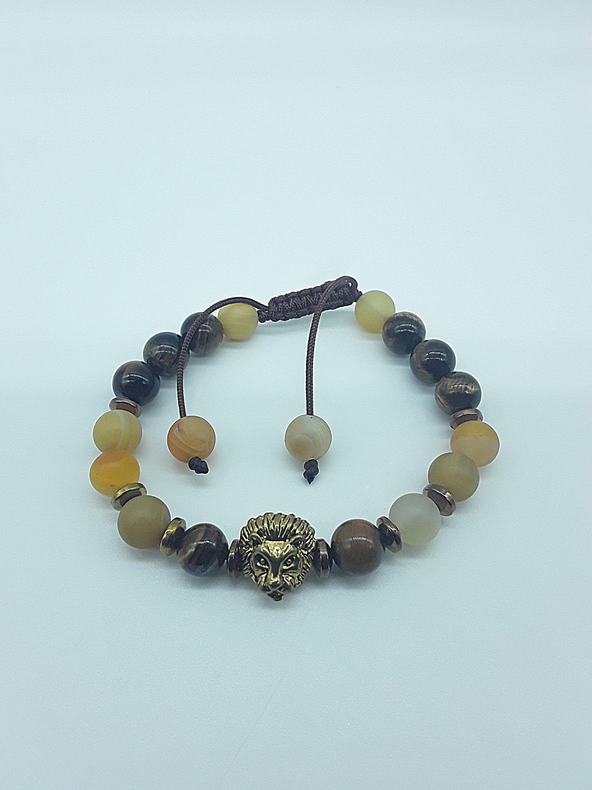The Lion’s Balance Bracelet by Polmadeva – Tiger’s Eye, Agate & Hematite bracelet with metallic lion charm symbolizing harmony, courage & grounding.