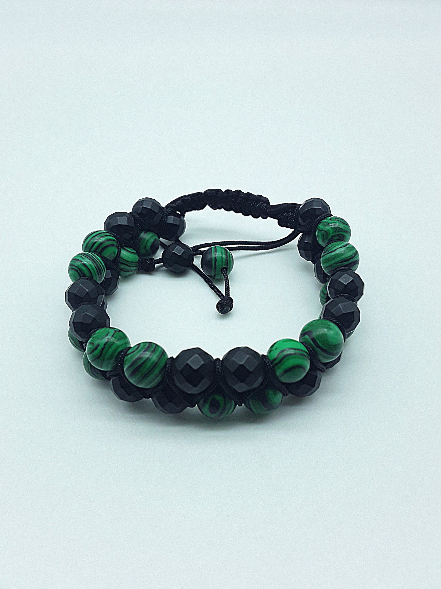 The Emerald Shadow Double Bracelet by Polmadeva – malachite and black onyx double bracelet symbolizing growth, grounding, and balanced strength