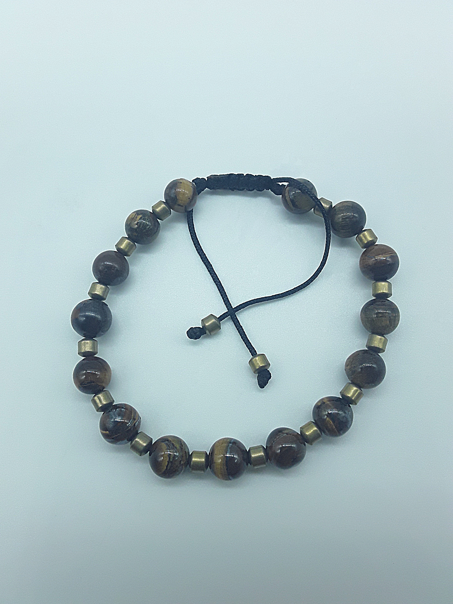 The Emberheart Bracelet by Polmadeva – tiger eye and hematite adjustable bracelet symbolizing courage, balance, and resilience