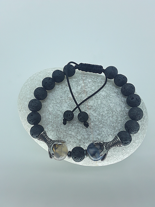 The Onyxfang Bracelet by Polmadeva – lava stone and dragon veins agate bracelet with stainless steel fangs symbolizing quiet strength and protection