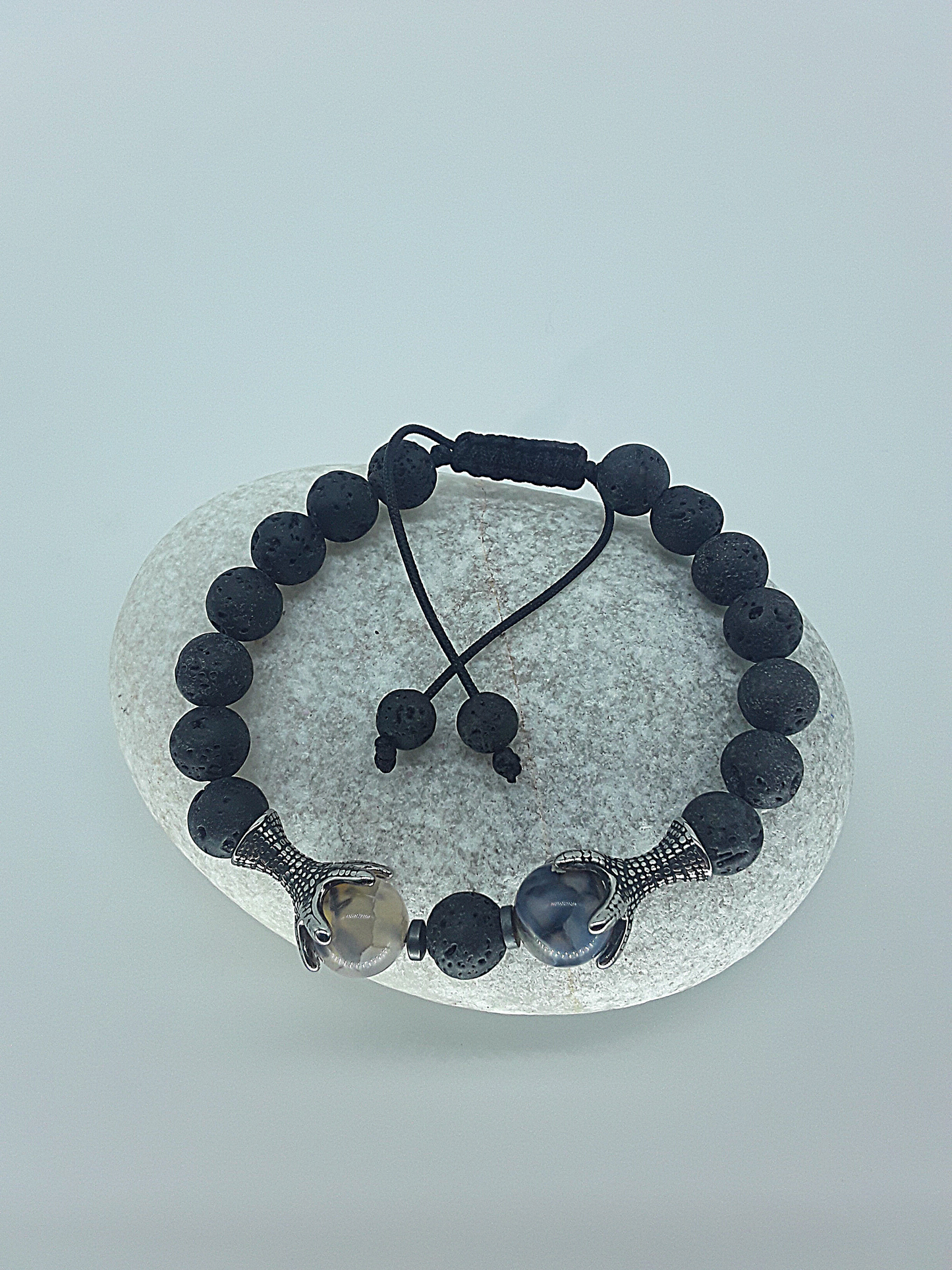 The Onyxfang Bracelet by Polmadeva – lava stone and dragon veins agate bracelet with stainless steel fangs symbolizing quiet strength and protection