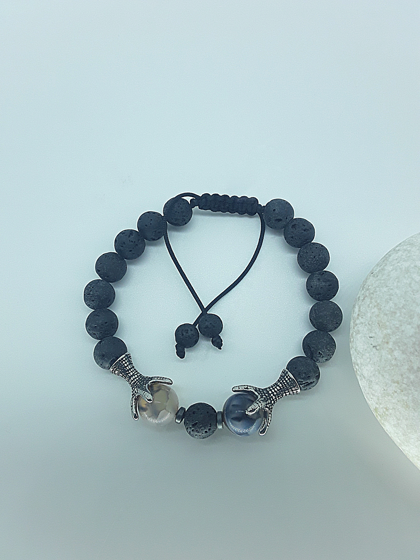 The Onyxfang Bracelet by Polmadeva – lava stone and dragon veins agate bracelet with stainless steel fangs symbolizing quiet strength and protection