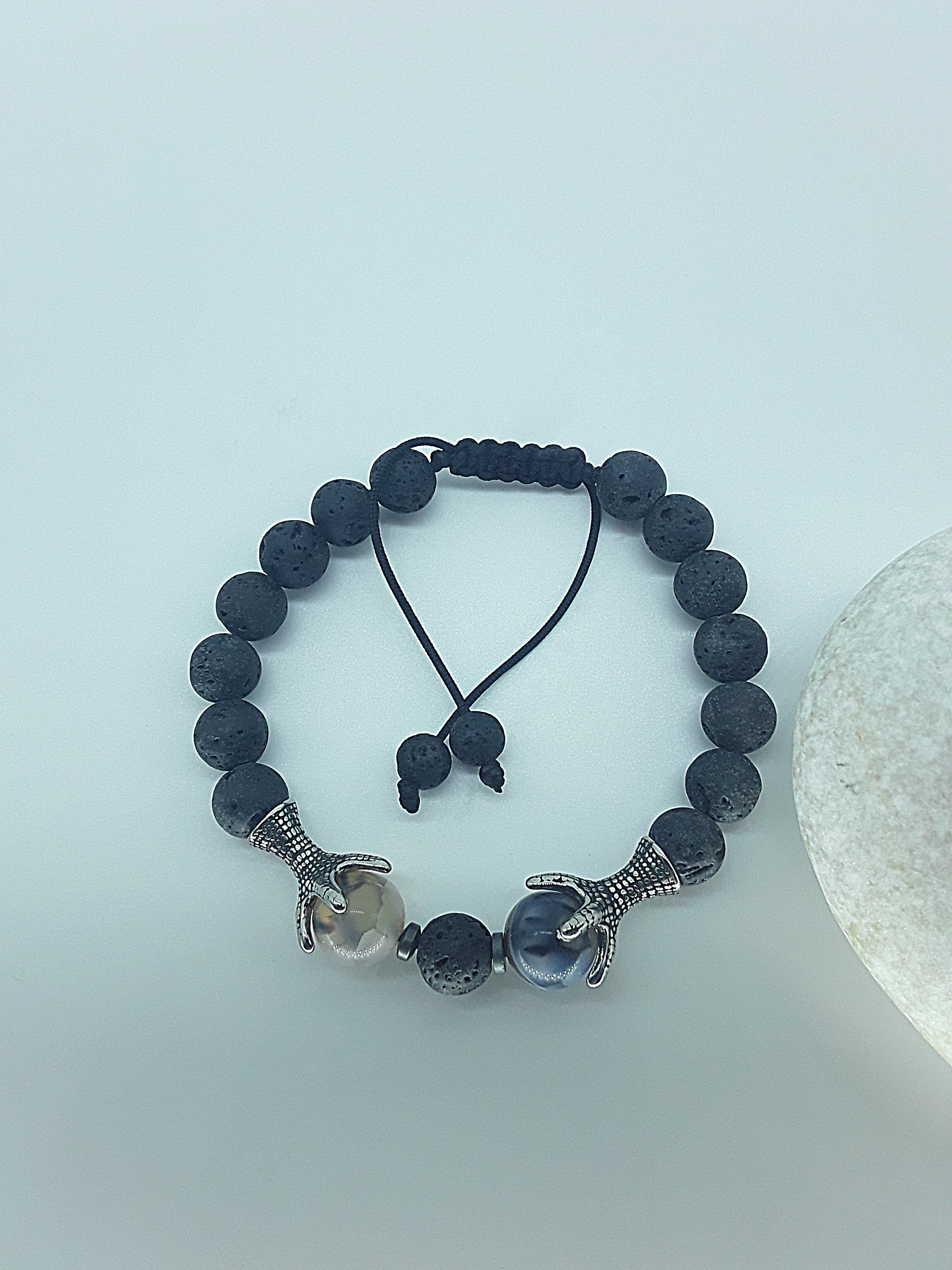 The Onyxfang Bracelet by Polmadeva – lava stone and dragon veins agate bracelet with stainless steel fangs symbolizing quiet strength and protection