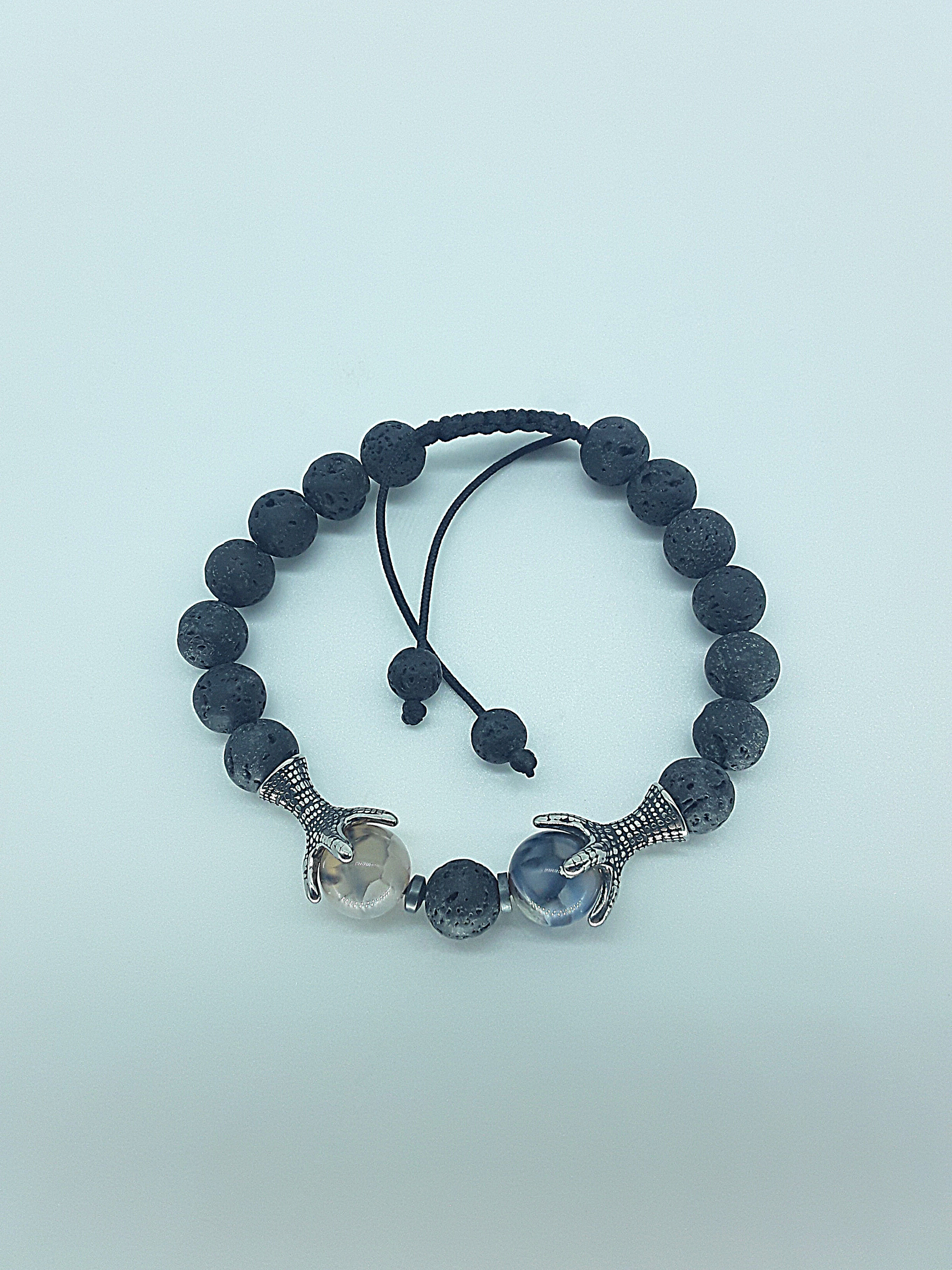 The Onyxfang Bracelet by Polmadeva – lava stone and dragon veins agate bracelet with stainless steel fangs symbolizing quiet strength and protection
