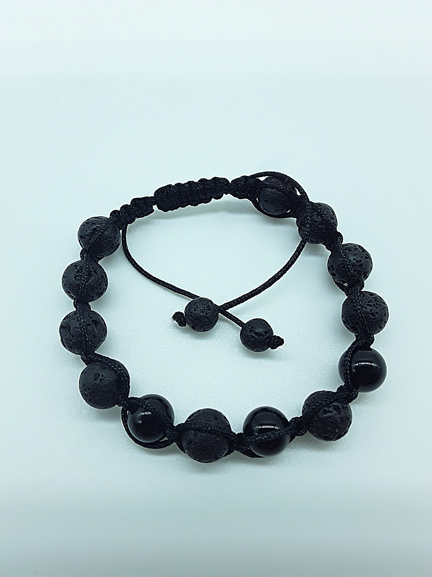The Phoenix Stone Bracelet by Polmadeva – lava stone and onyx bracelet symbolizing renewal, grounding, and new beginnings