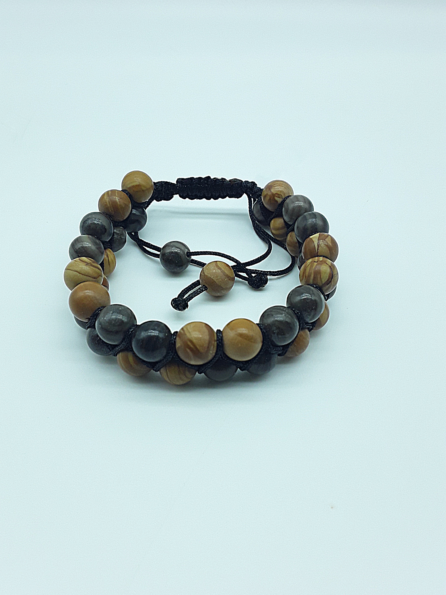 The Earth Harmony Double Bracelet by Polmadeva – Black Wood Lace Stone & Tigerskin Jasper bracelet symbolizing grounding, balance, and harmony.
