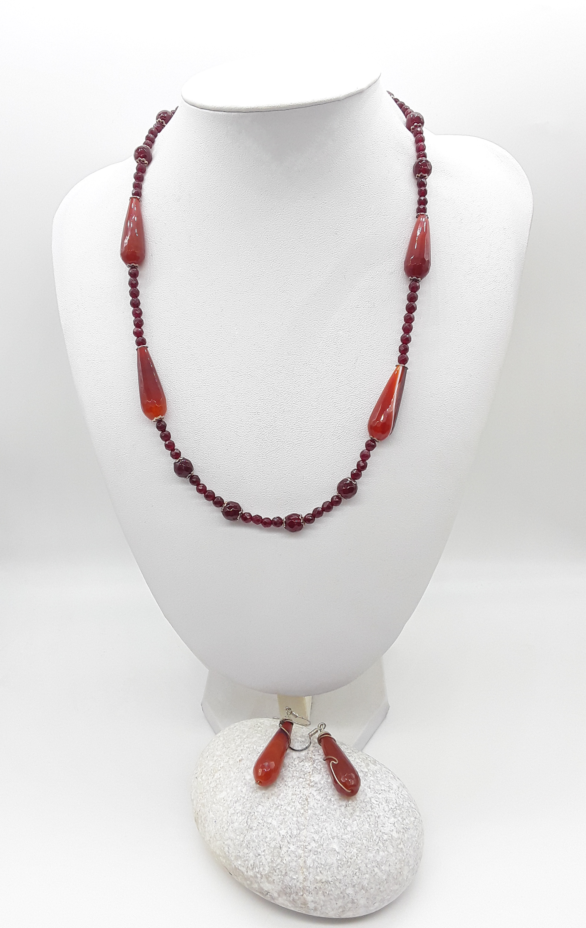 Close-up of Polmadeva’s Tears of Renewal Set showing tear-shaped red agate beads framed in silver
