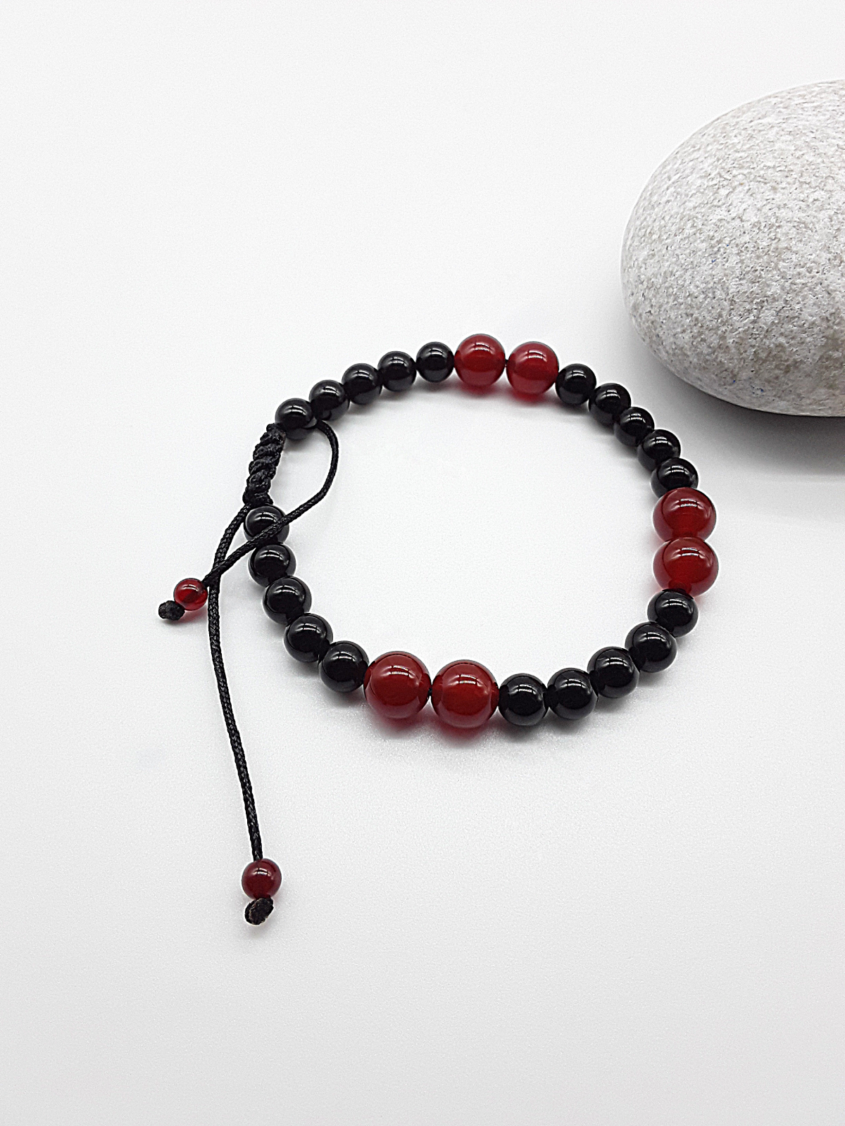 The Vital Pulse Bracelet by Polmadeva – carnelian and black onyx bracelet symbolizing vitality, balance, and quiet strength