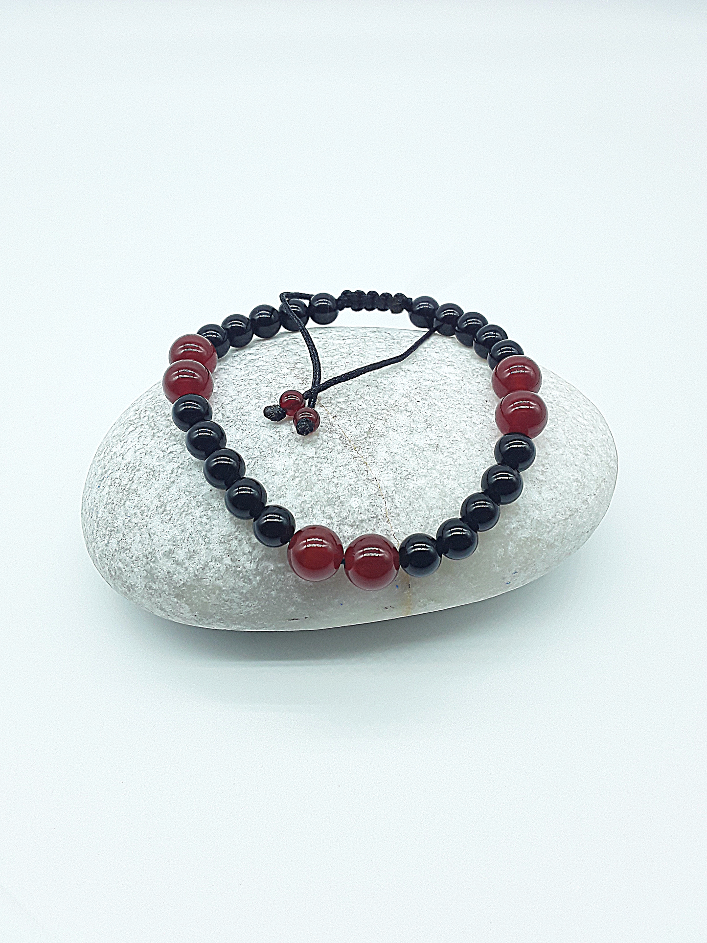 The Vital Pulse Bracelet by Polmadeva – carnelian and black onyx bracelet symbolizing vitality, balance, and quiet strength