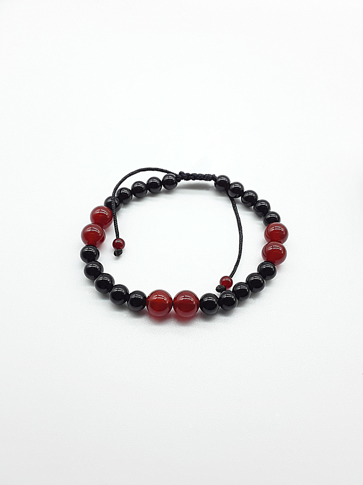The Vital Pulse Bracelet by Polmadeva – carnelian and black onyx bracelet symbolizing vitality, balance, and quiet strength