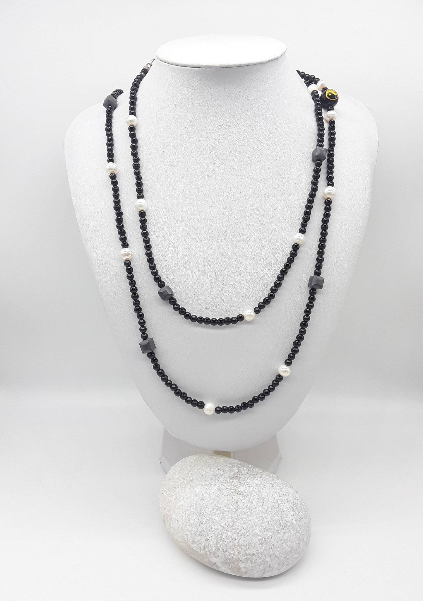 The Yin–Yang Guardian Necklace by Polmadeva – black onyx, hematite and freshwater pearl necklace with yin–yang bead symbolizing harmony, balance, and strength