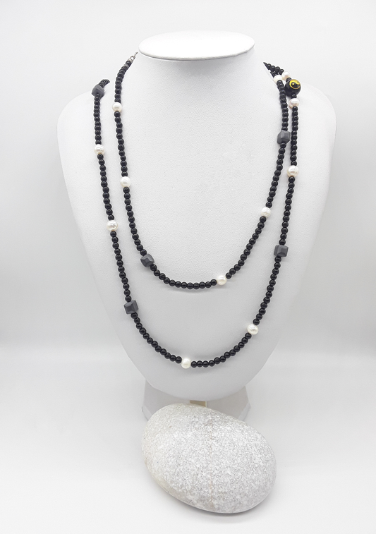 The Yin–Yang Guardian Necklace by Polmadeva – black onyx, hematite and freshwater pearl necklace with yin–yang bead symbolizing harmony, balance, and strength