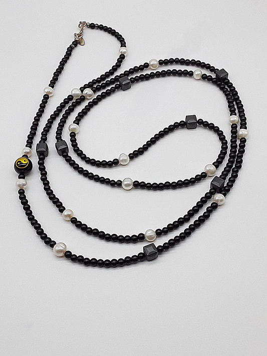 The Yin–Yang Guardian Necklace by Polmadeva – black onyx, hematite and freshwater pearl necklace with yin–yang bead symbolizing harmony, balance, and strength