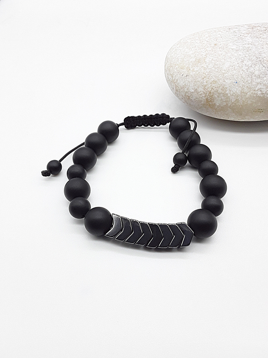 The Silent Arrow Bracelet by Polmadeva – black onyx and hematite bracelet with silver arrow accents symbolizing balance, focus, and quiet strength