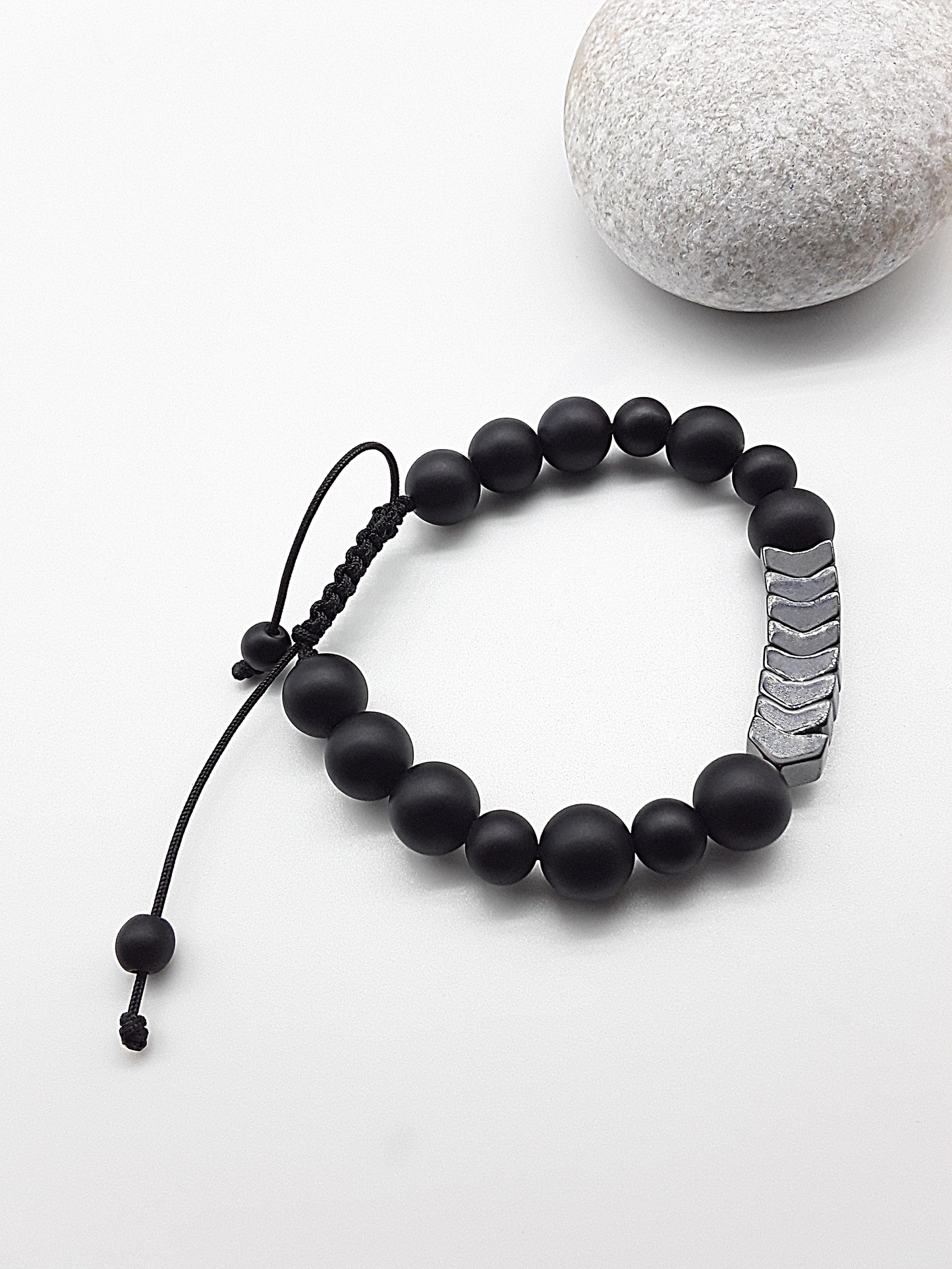The Silent Arrow Bracelet by Polmadeva – black onyx and hematite bracelet with silver arrow accents symbolizing balance, focus, and quiet strength