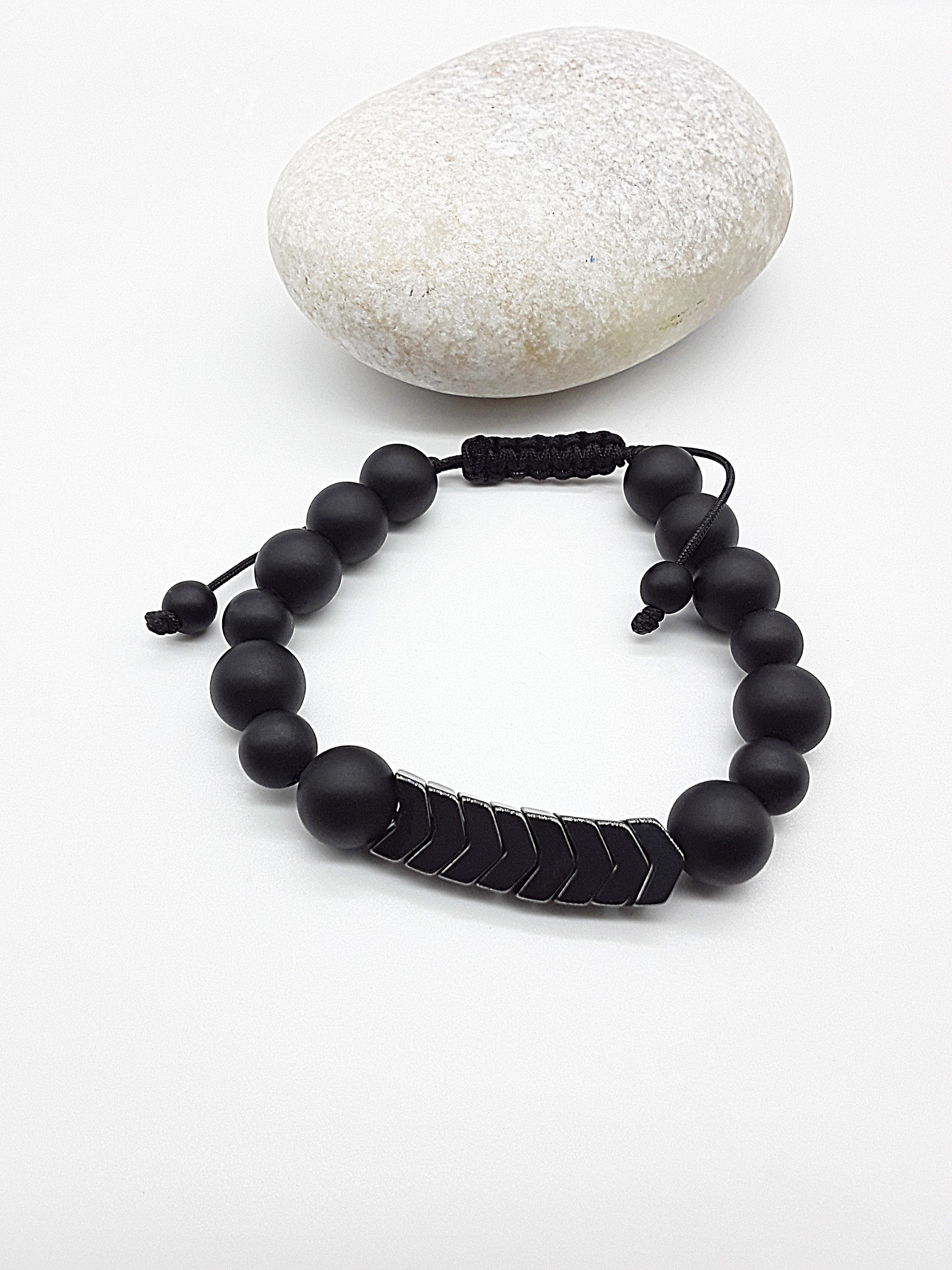 The Silent Arrow Bracelet by Polmadeva – black onyx and hematite bracelet with silver arrow accents symbolizing balance, focus, and quiet strength