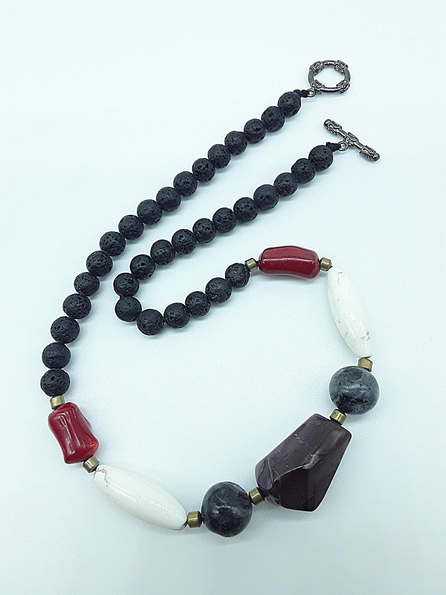 The Flamebound Necklace by Polmadeva – mookaite, lava stone, red coral, turquoise and hematite necklace symbolizing courage, fire, and transformation