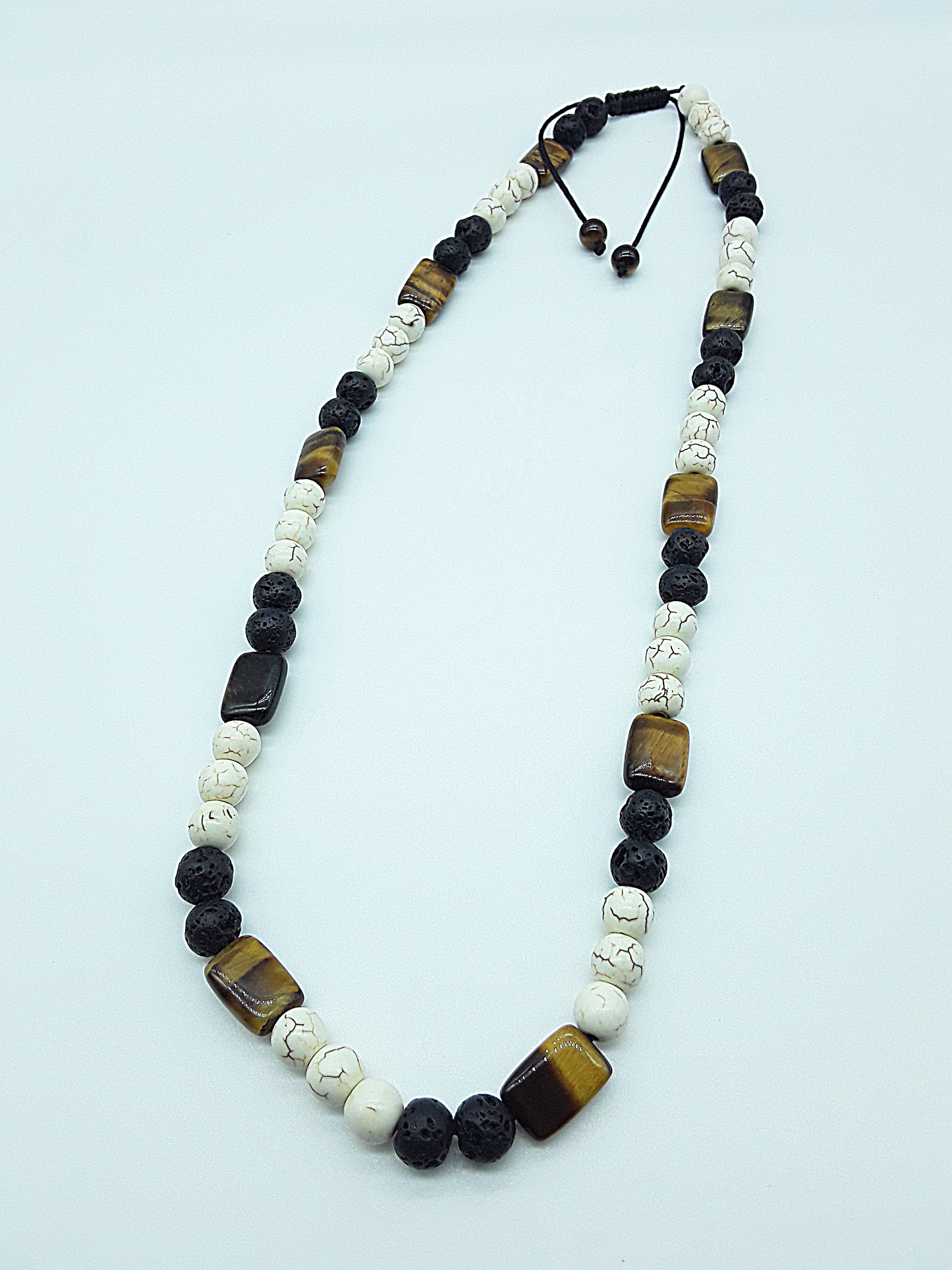 The Stone of Three Paths Set by Polmadeva – handcrafted necklace & bracelet with Lava Stone, Tiger’s Eye & Howlite, symbolizing vision, grounding & harmony.