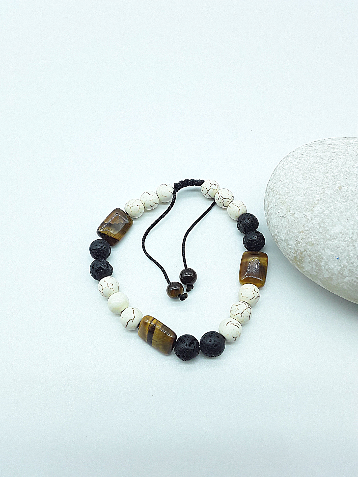 The Stone of Three Paths Set by Polmadeva – handcrafted necklace & bracelet with Lava Stone, Tiger’s Eye & Howlite, symbolizing vision, grounding & harmony.
