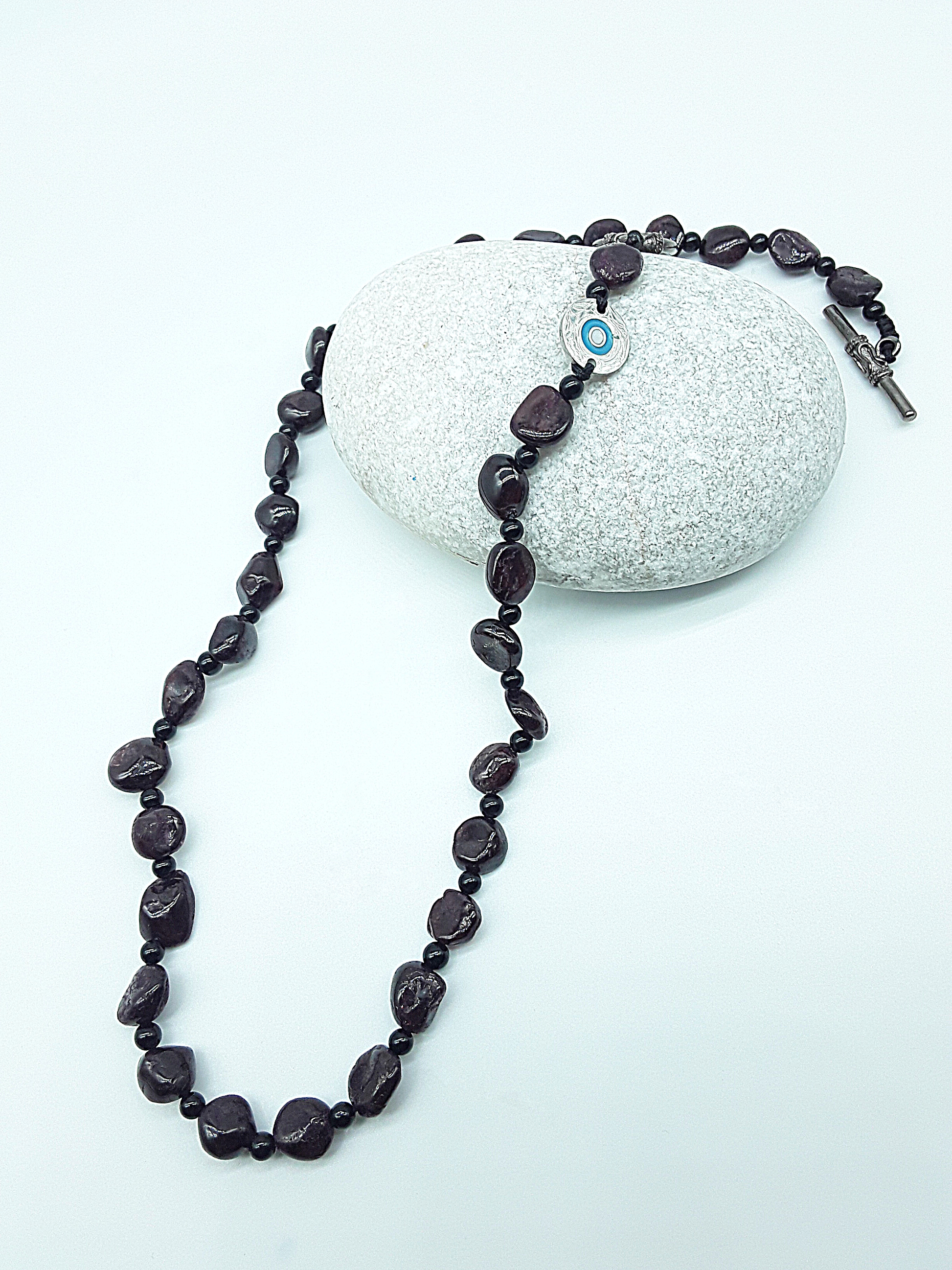 The Sigilguard Necklace by Polmadeva – garnet and onyx necklace with sigil pendant symbolizing protection, courage, and resilience