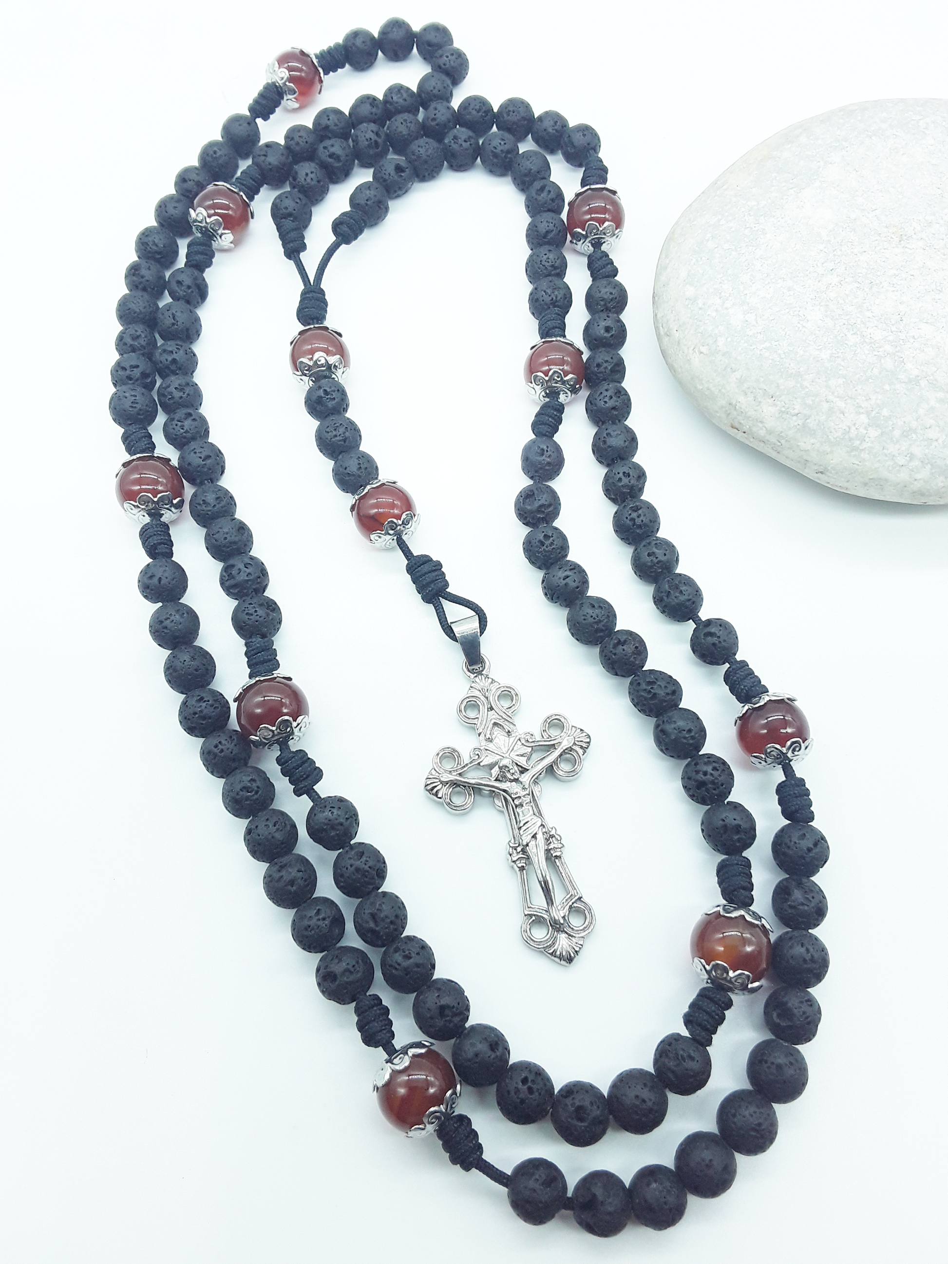Carried Through Time lava stone and carnelian 10-decade Catholic rosary beside stone by Polmadeva