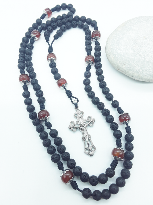 Carried Through Time lava stone and carnelian 10-decade Catholic rosary beside stone by Polmadeva