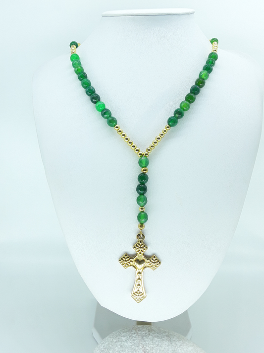 Traditional Catholic rosary made with natural green agate beads, hematite spacers, and a stainless steel heart-shaped cross, displayed on a white bust.
