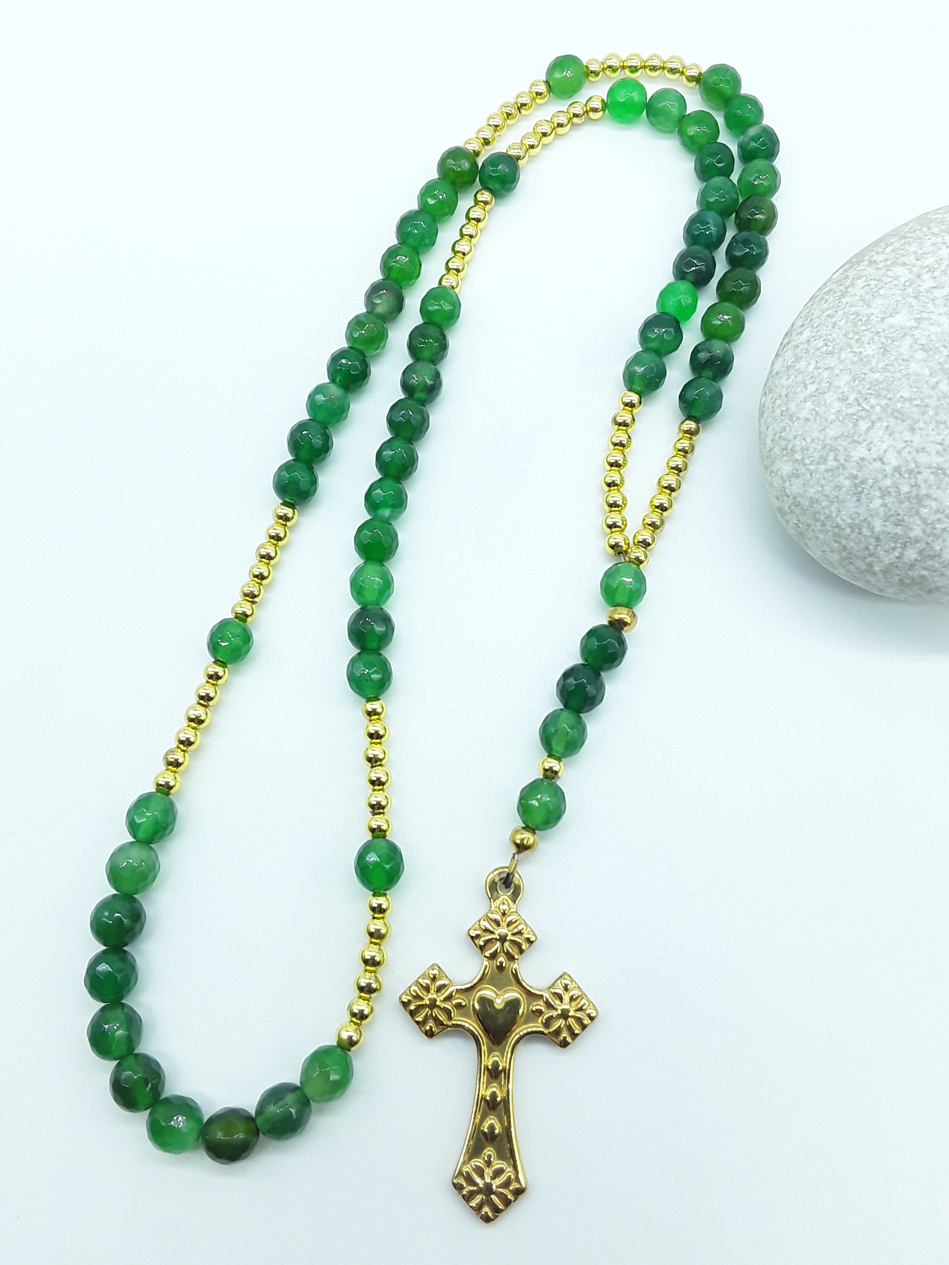 Traditional Catholic rosary made with natural green agate beads, hematite spacers, and a stainless steel heart-shaped cross, displayed on a white bust.
